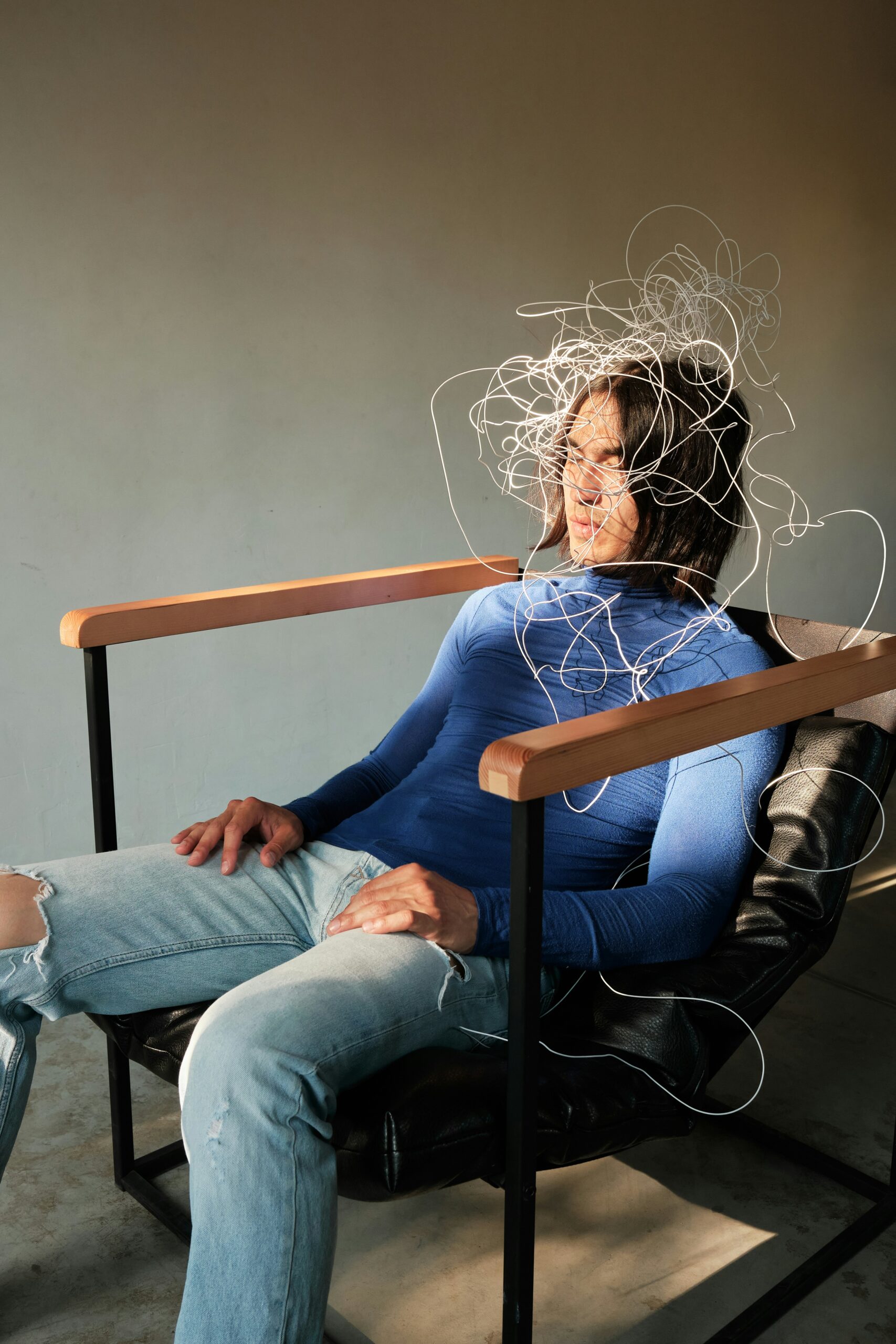 A man sits in a chair with wires on his head, symbolizing a need for adult ADHD resources and support.