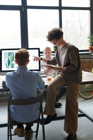 Two adults work together in front of a computer applying for jobs through NeuroSpark Health's career page.