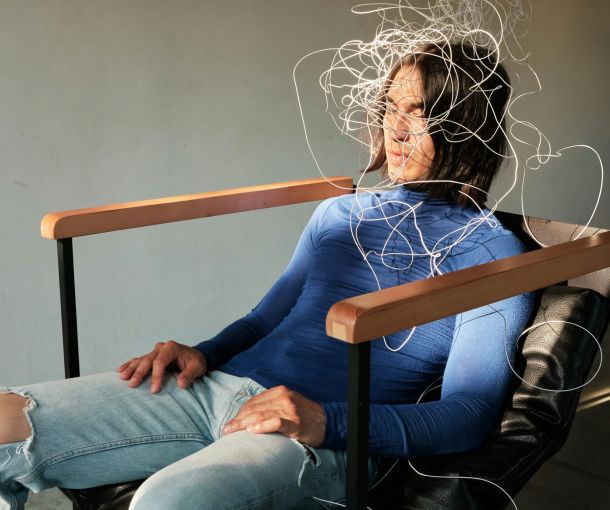 A man sits in a chair with wires on his head, symbolizing a need for adult ADHD resources and support.