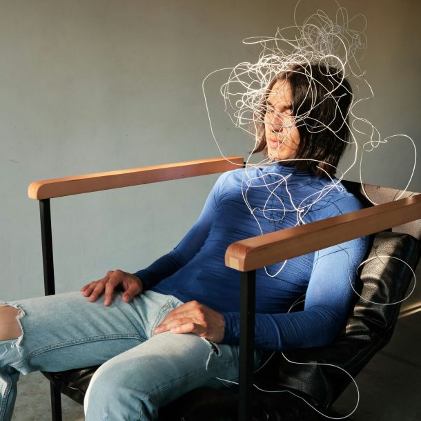 A man sits in a chair with wires on his head, symbolizing a need for adult ADHD resources and support.