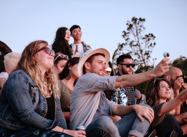 A group of friends outside represent the collegial environment of NeuroSpark Health careers.