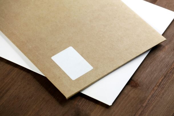 One brown folder and one white folder on a wooden table represent the official documentation provided as part of NeuroSpark Health's assessment process.